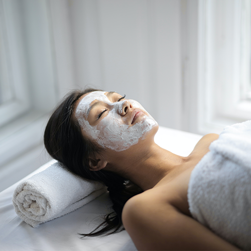 A young woman getting a facial