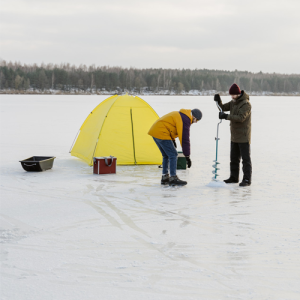 two men fishing on a river with a little yellow tent on the ice