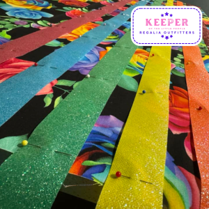 Bright coloured ribbons pinned onto skirt fabric.