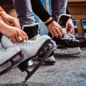 people lacing up ice skates
