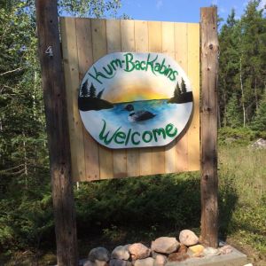 Rustic wooden "Welcome" sign for the lodge