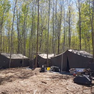Three tents set up at camp in the spring